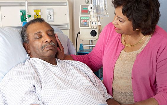 Mature woman comforting her husband in the Emergency Room.