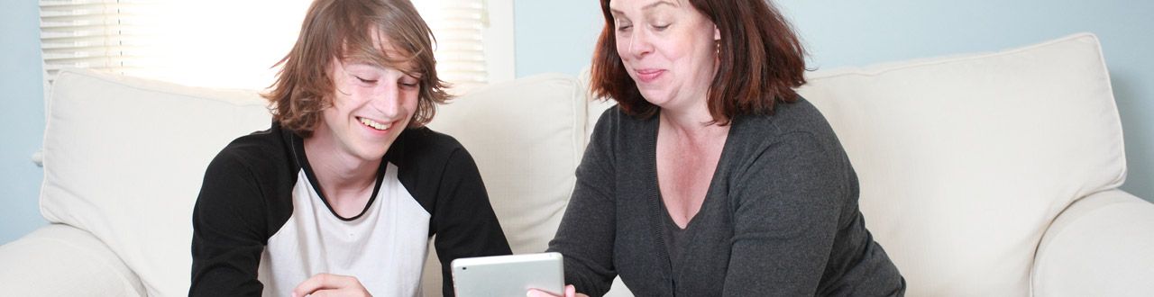 Mom shows her son something important on her iPad